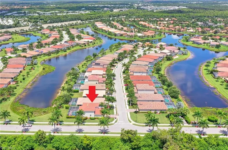 Aerial view of residential area featuring a large body of water