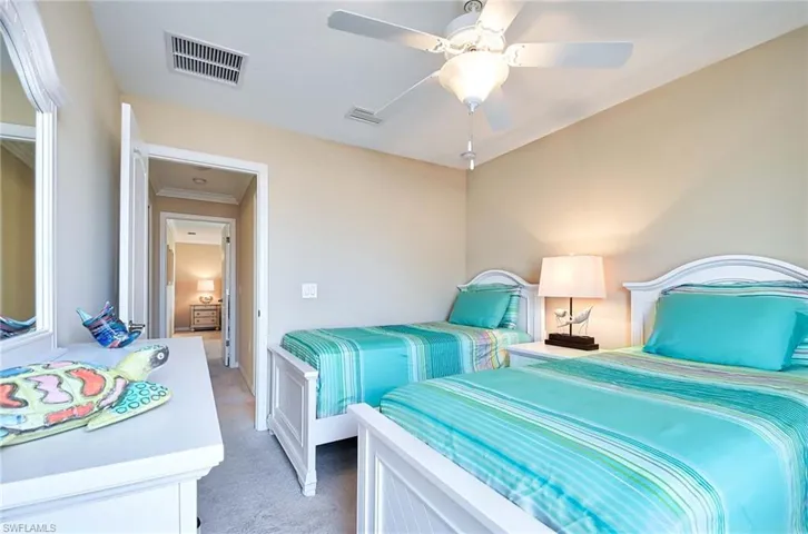 Bedroom featuring light colored carpet, ceiling fan, and crown molding