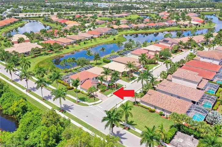 Aerial perspective of suburban area featuring a nearby body of water