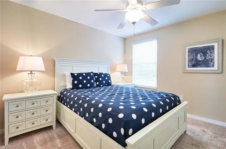 Bedroom with carpet floors, baseboards, and ceiling fan