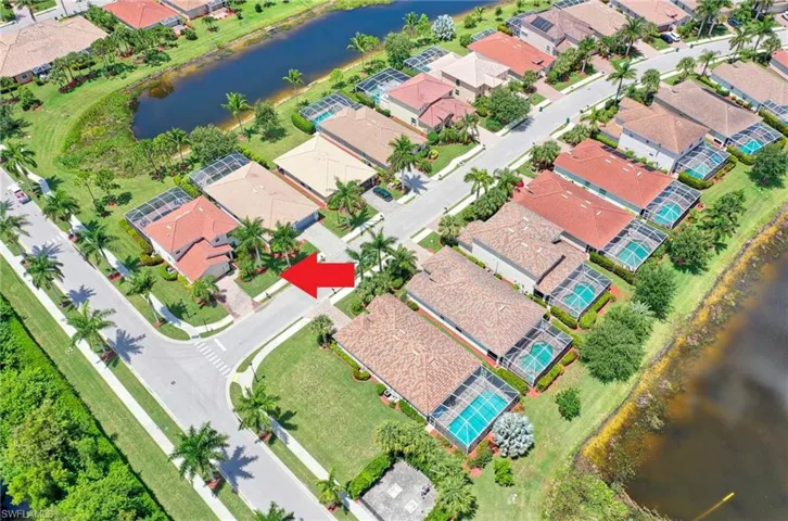 Aerial view of property's location with a nearby body of water and nearby suburban area