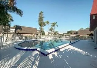 View of community swimming pool with a patio