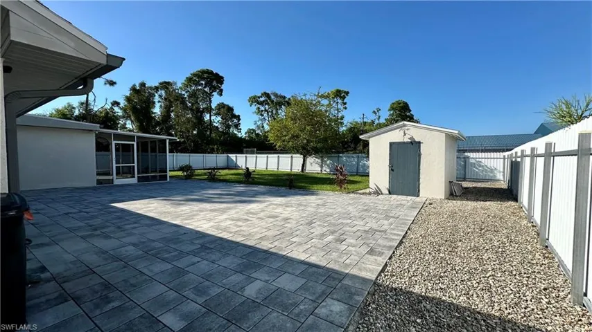 View of patio with a shed