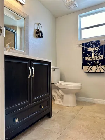 Bathroom with tile patterned floors, vanity, and toilet