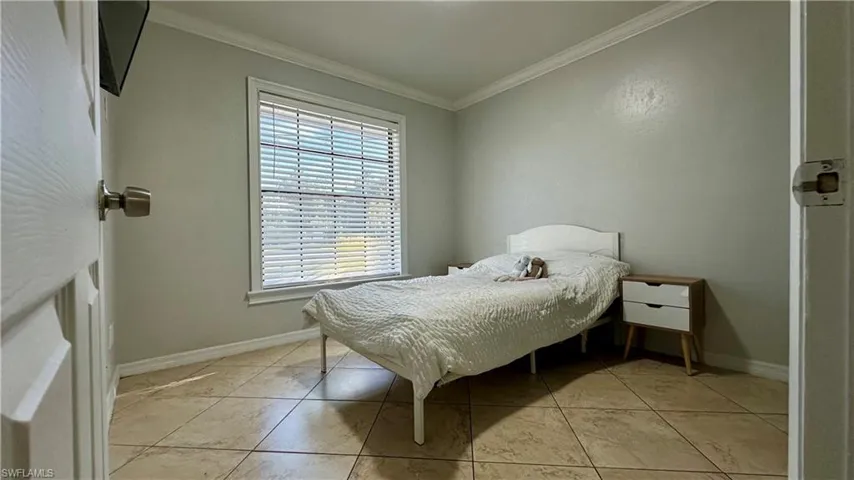 Tiled bedroom with ornamental molding