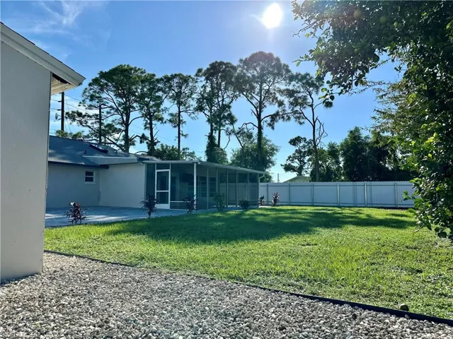 View of yard with a sunroom and a patio area