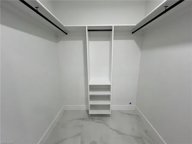 Walk in closet featuring tile floors
