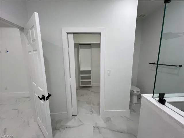 Bathroom featuring tile flooring and toilet