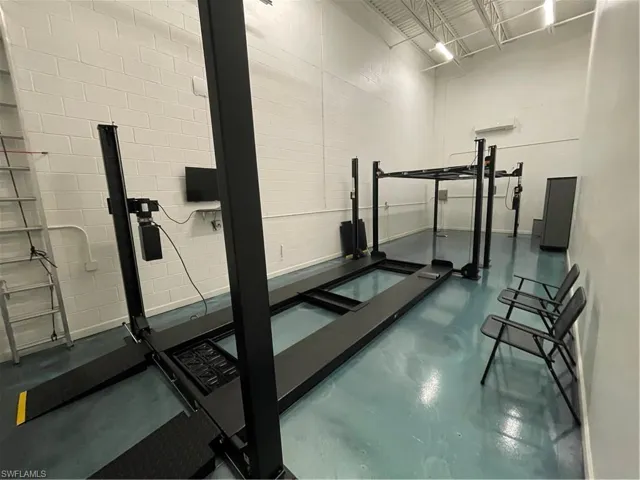 Exercise room featuring concrete floors