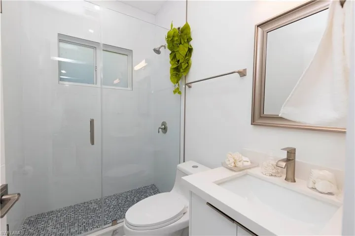Bathroom featuring vanity and a stall shower