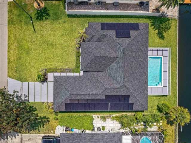 Aerial view of property and surrounding area featuring a pool area