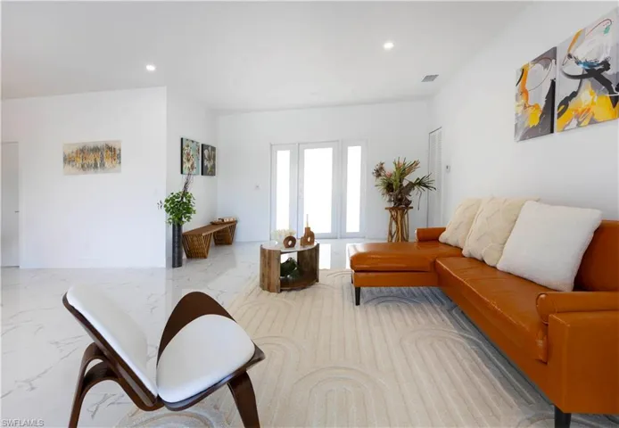 Living room featuring recessed lighting and marble finish flooring
