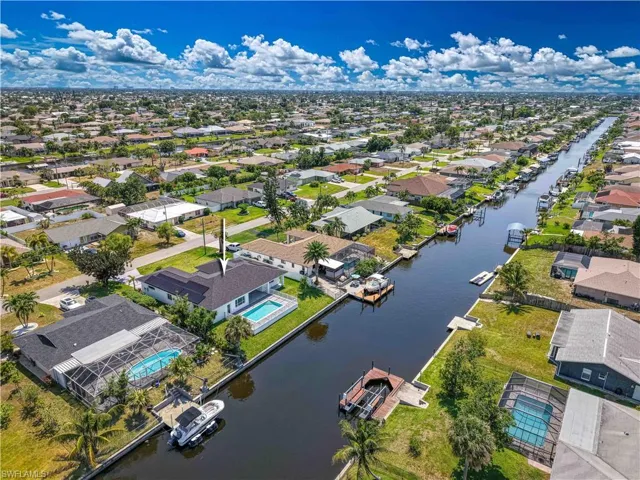 Aerial perspective of suburban area featuring a large body of water