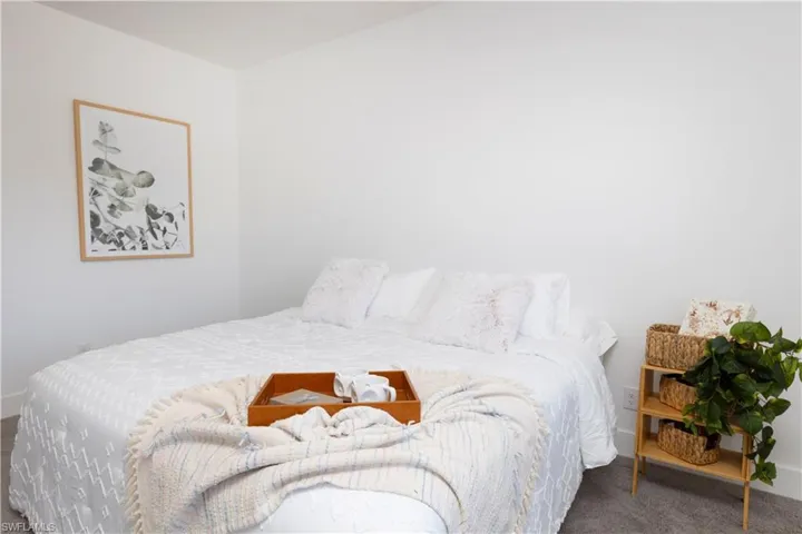 Carpeted bedroom with baseboards