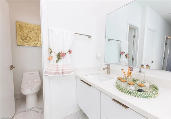 Bathroom featuring vanity and marble look tile flooring
