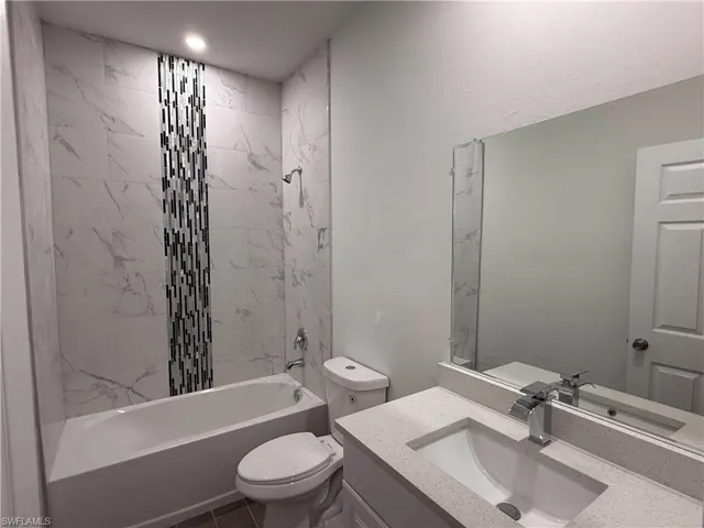 Full bathroom featuring tub / shower combination and vanity