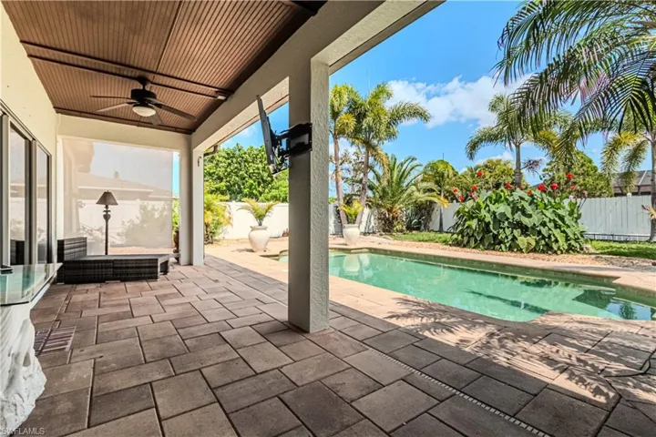 View of pool with a patio and ceiling fan