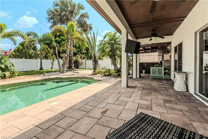 View of pool featuring ceiling fan and a patio