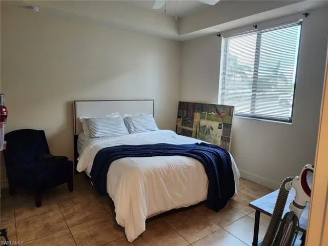 Tiled bedroom with ceiling fan