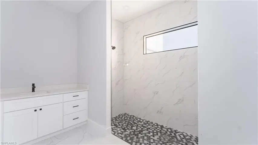 Bathroom with a tile shower and vanity