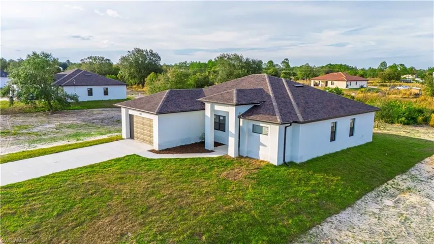 View of front of house featuring a front yard and a garage