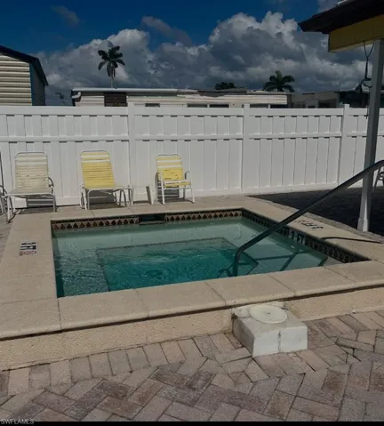 View of community hot tub featuring a patio area