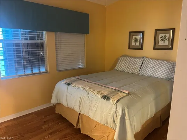 Bedroom with hardwood / wood-style floors