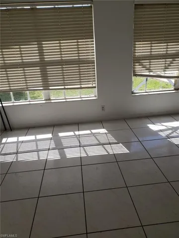 Empty room with a wealth of natural light and light tile patterned floors