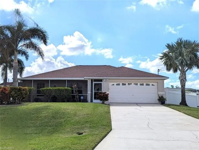 Single story home with a front yard and a garage