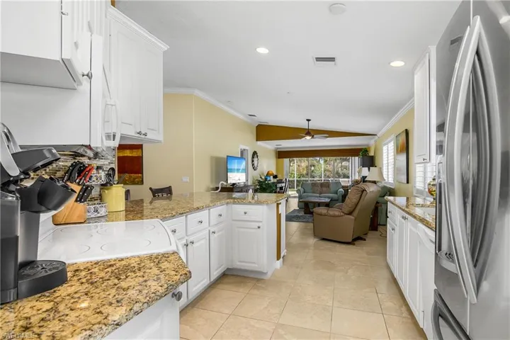 White cabinets and tile leading all the way to lanai