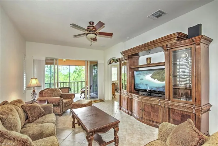 Tiled living room featuring ceiling fan