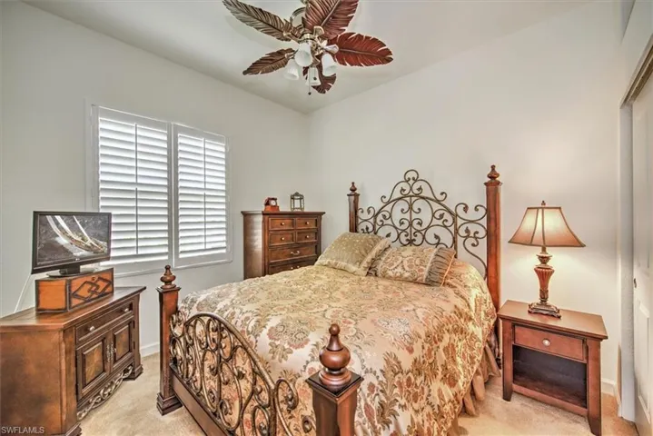 Carpeted bedroom with ceiling fan