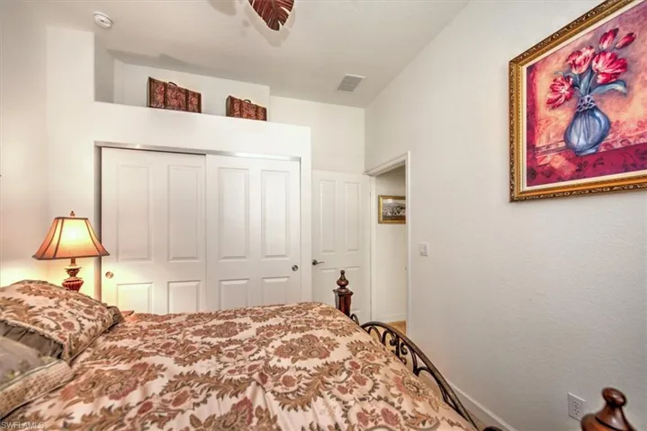Bedroom featuring ceiling fan and a closet