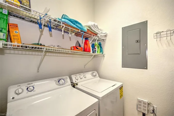 Washroom featuring washing machine and clothes dryer and electric panel
