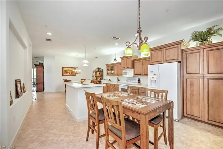Dining area featuring light tile patterned flooring and a chandelier