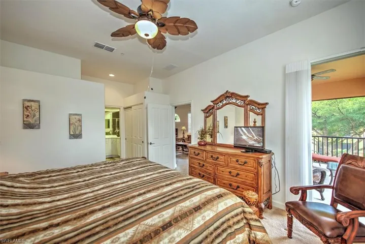 Bedroom featuring connected bathroom, access to outside, and ceiling fan