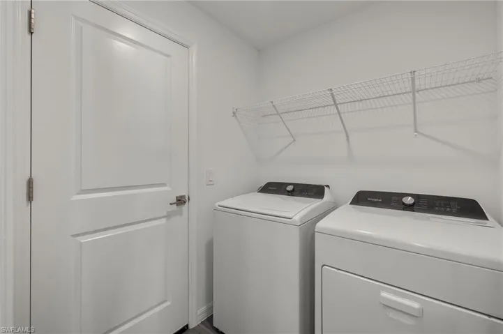 Washroom featuring laundry area and washing machine and clothes dryer