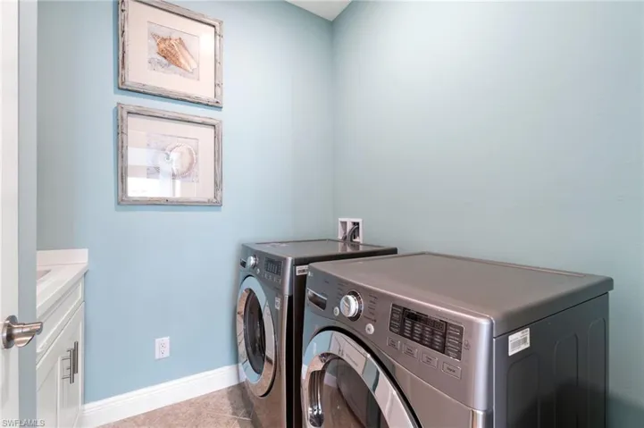 Laundry room with sink and storage over sink