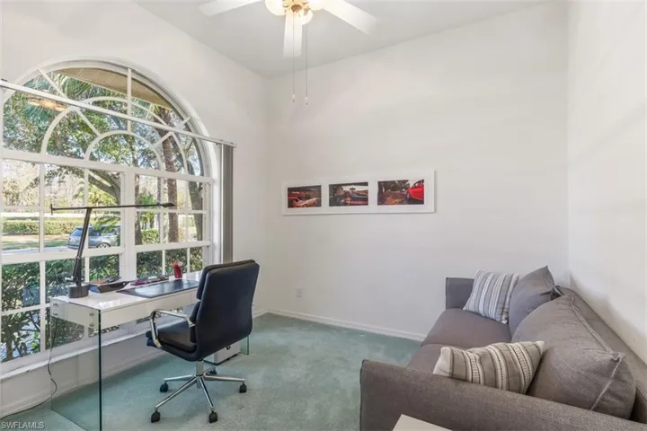 Third bedroom converted to home office with pull-out sofa bed. beautiful arched window