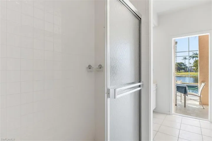 Full bathroom featuring glass door to lanai