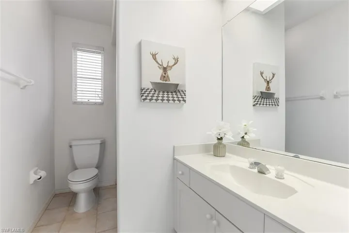 Third guest full bathroom with vanity and light tile patterned floors