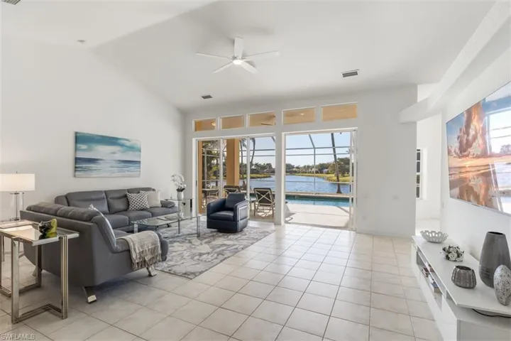 Living room featuring vaulted ceiling, long water western view