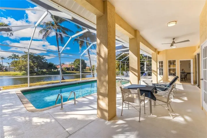 Lanai/pool featuring  sunroom, patio, glass enclosure, and a water view