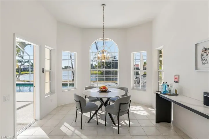 Breakfast area, arched window & glass door to pool/lanai