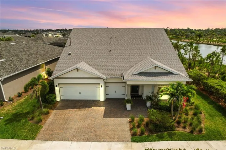 View of front of property featuring a garage and a water view