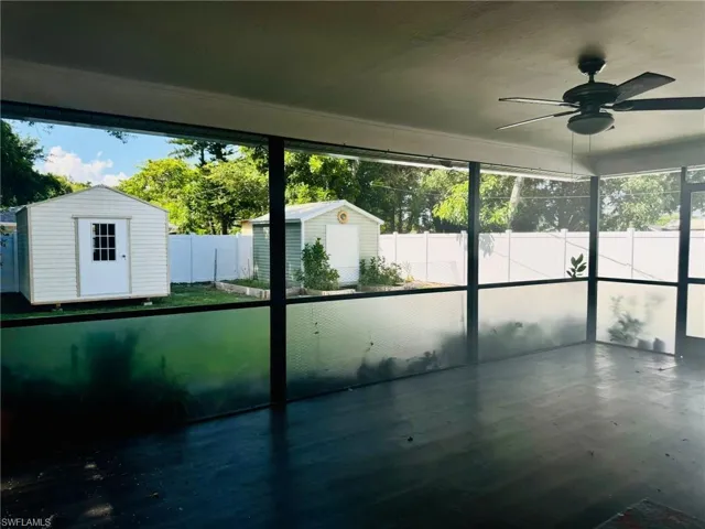 Unfurnished sunroom with ceiling fan