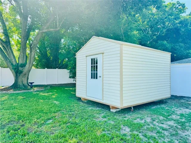 View of outdoor structure with a lawn