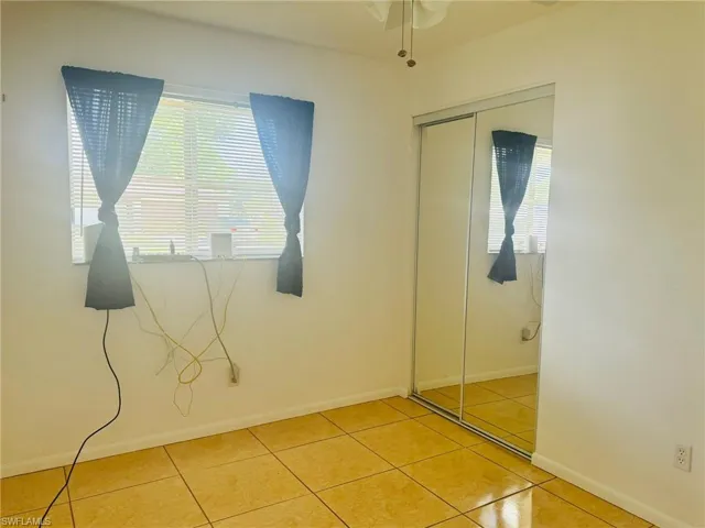Unfurnished bedroom with a closet and tile patterned floors