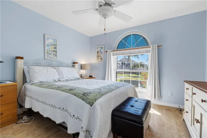 Bedroom with baseboards, ceiling fan, and light wood finished floors