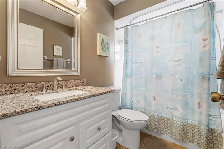 Full bathroom featuring toilet and vanity